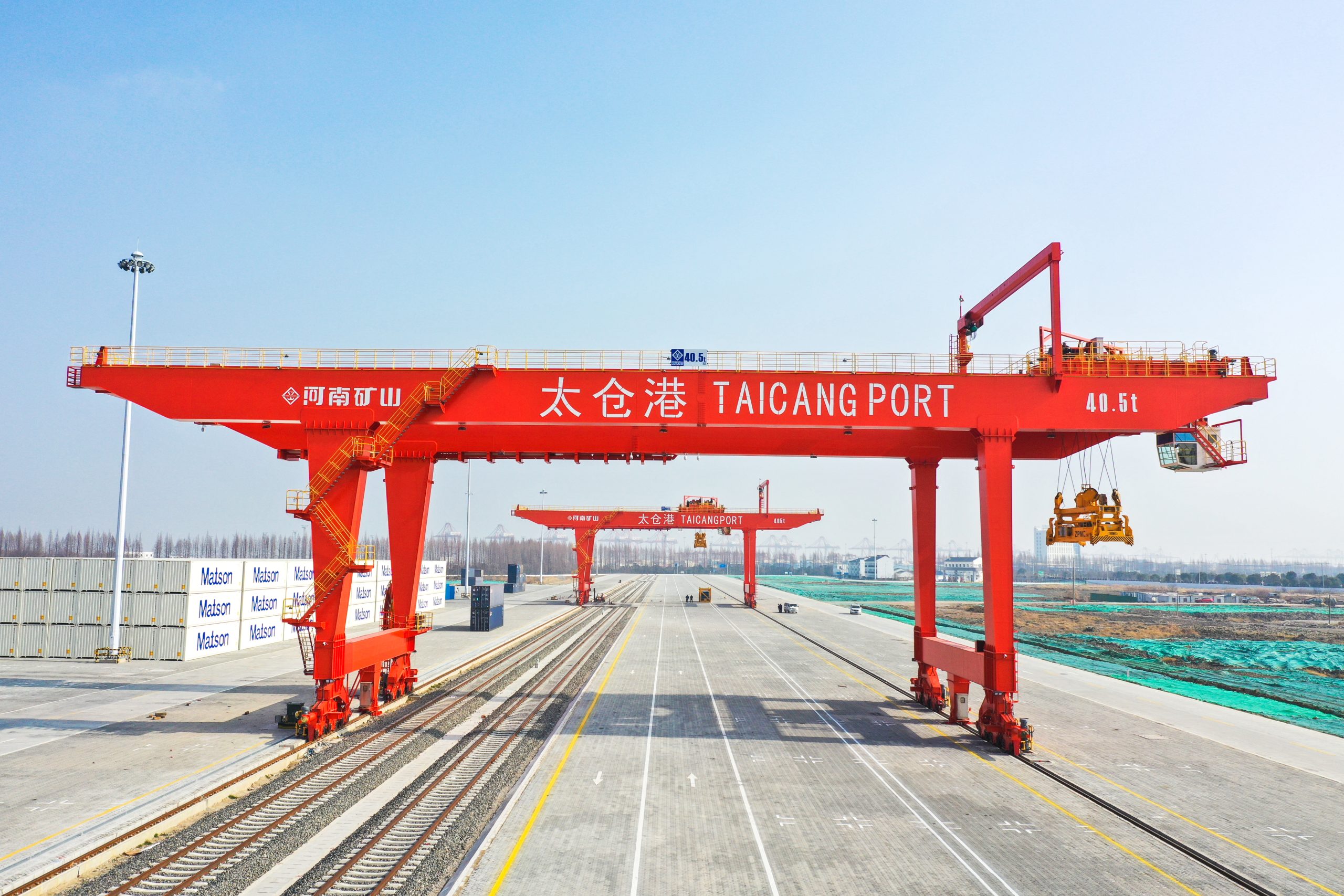 Henan Mine Crane rail-mounted container gantry cranes operating over rail tracks and truck lanes at Taicang Port